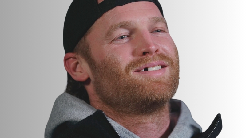 A Man with A Beard and Cap, Smiling with A Missing Front Tooth